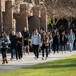 Group of UCR students walking on to campus