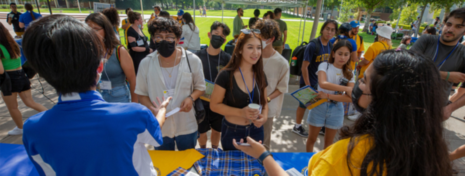Incoming UCR students meet introduce themselves to a represent from a campus organization during a Highlander Orientation tabling fair. 