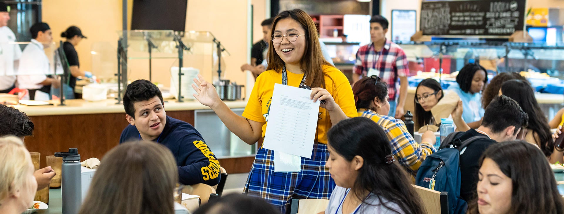 Incoming UCR students enjoy a meal with their Highlander Orientation leaders in a campus dining hall. 